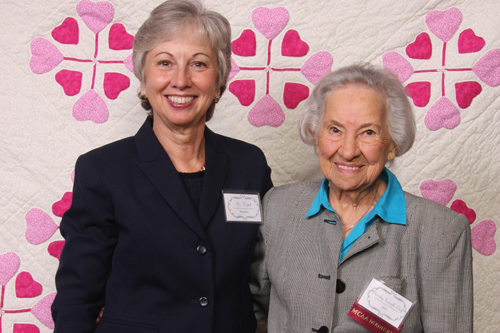 dr-wynd-and-dorothy-gorenflo-cluff-42-with-the-quilt-dorothy-designed-and-made-to-raise-funds-for-student-scholarships